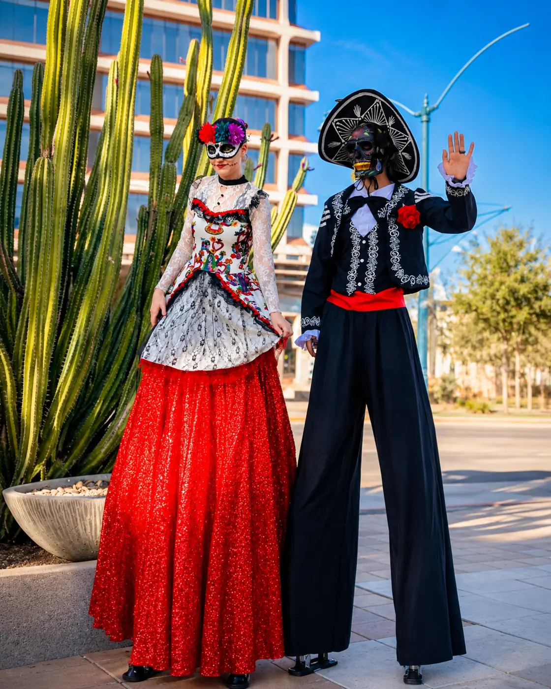 Tabitha and Dan in coordinated Day of the Dead stilt costumes