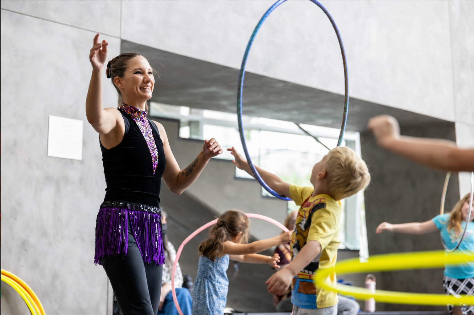 Tabitha guiding children through hands-on hula hoop activities