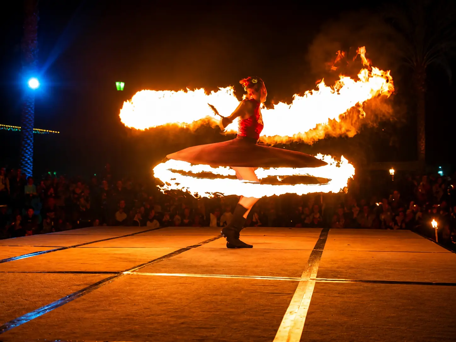 Tabitha spinning the Fire Whirling Skirt during a nighttime stage show