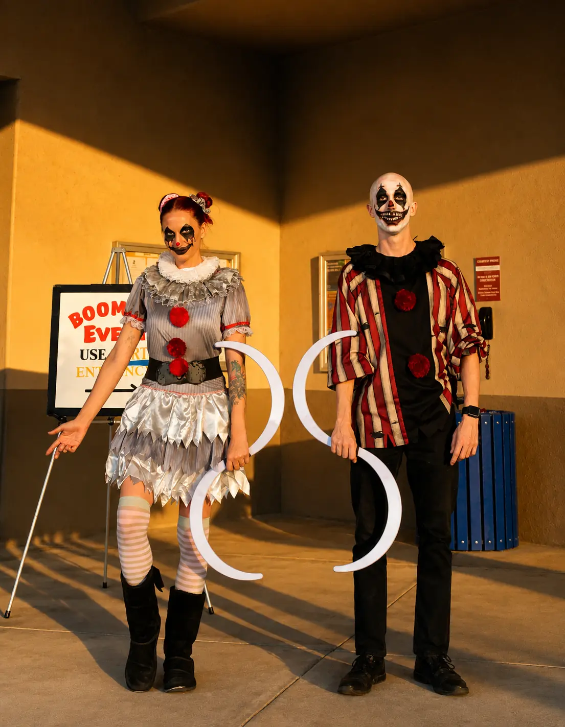 Dan and Tabitha in coordinated eerie clown costumes holding illuminated hoops