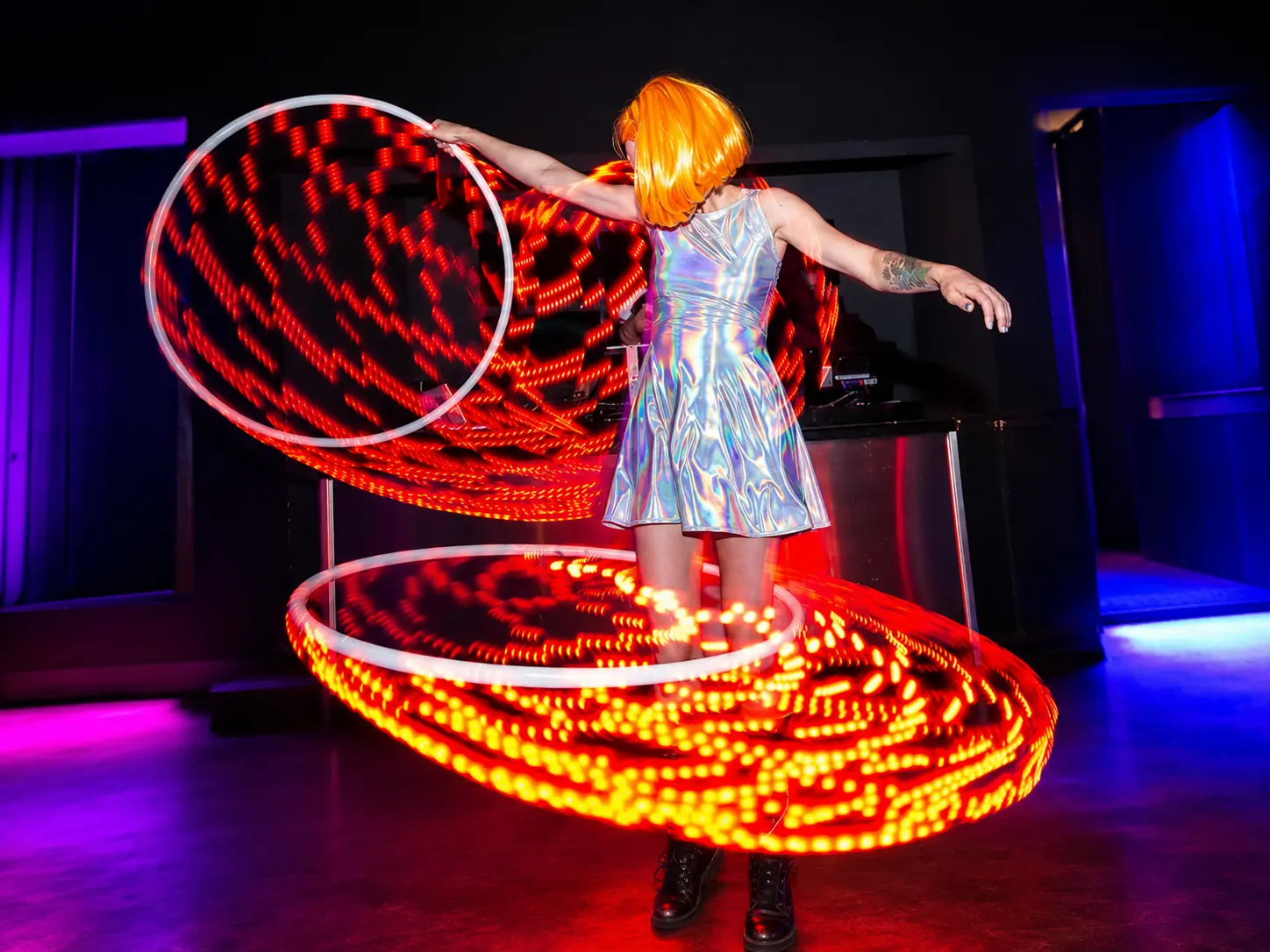 Tabitha creating red light trails with multiple LED hoops