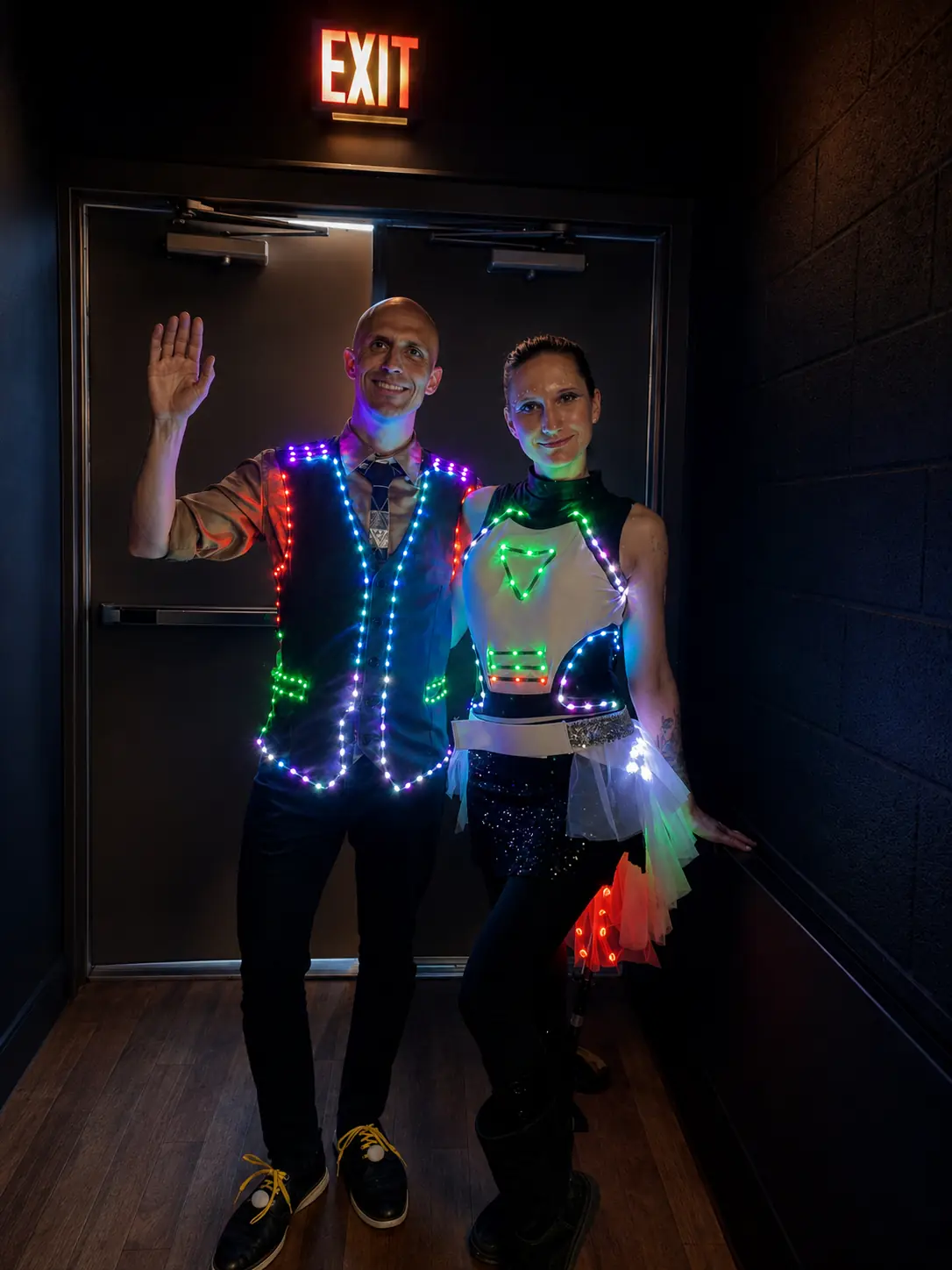 Dan and Tabitha wearing coordinated programmable LED performance costumes