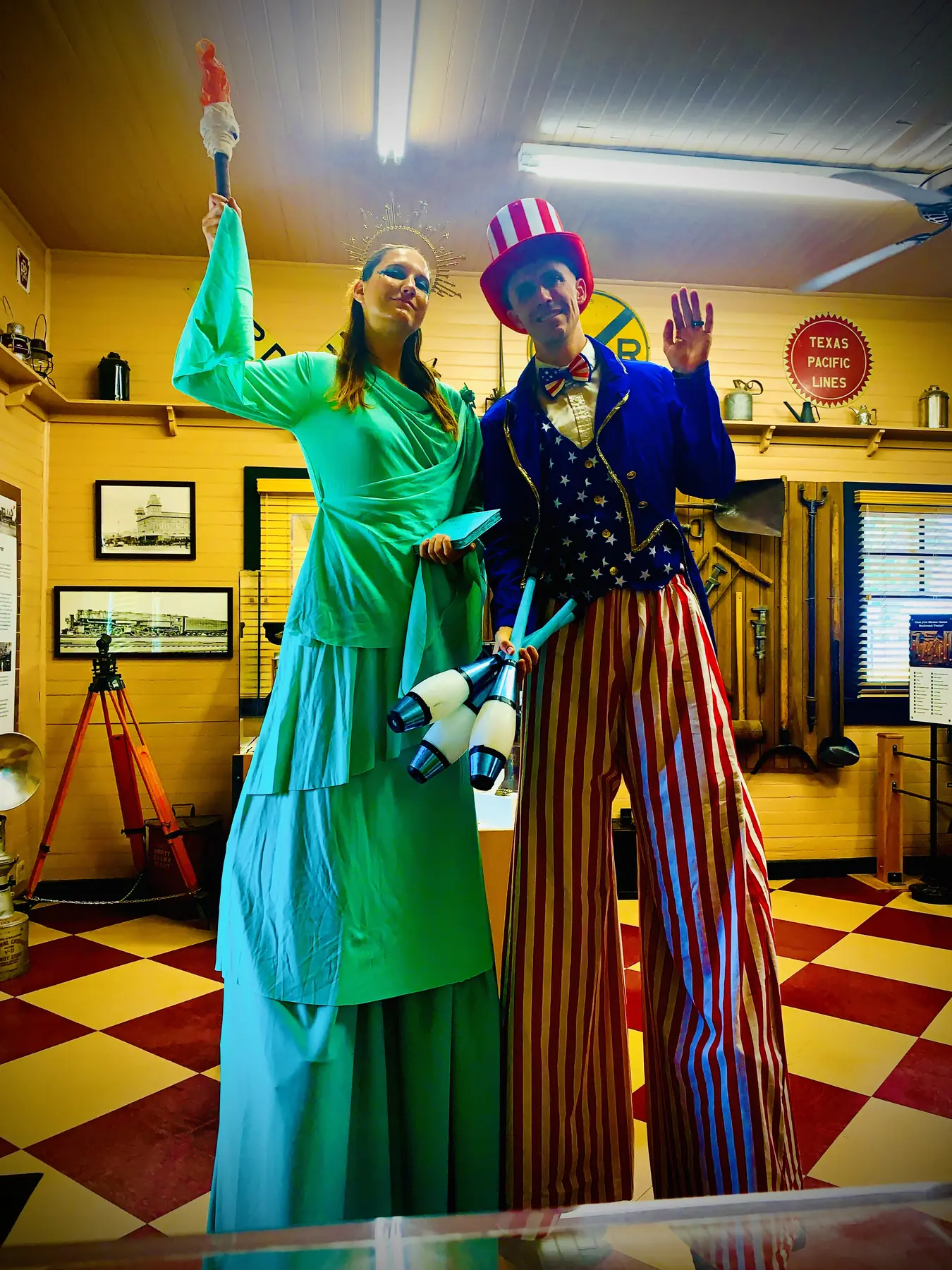 Tabitha as the Statue of Liberty and Dan as Uncle Sam on stilts with juggling clubs